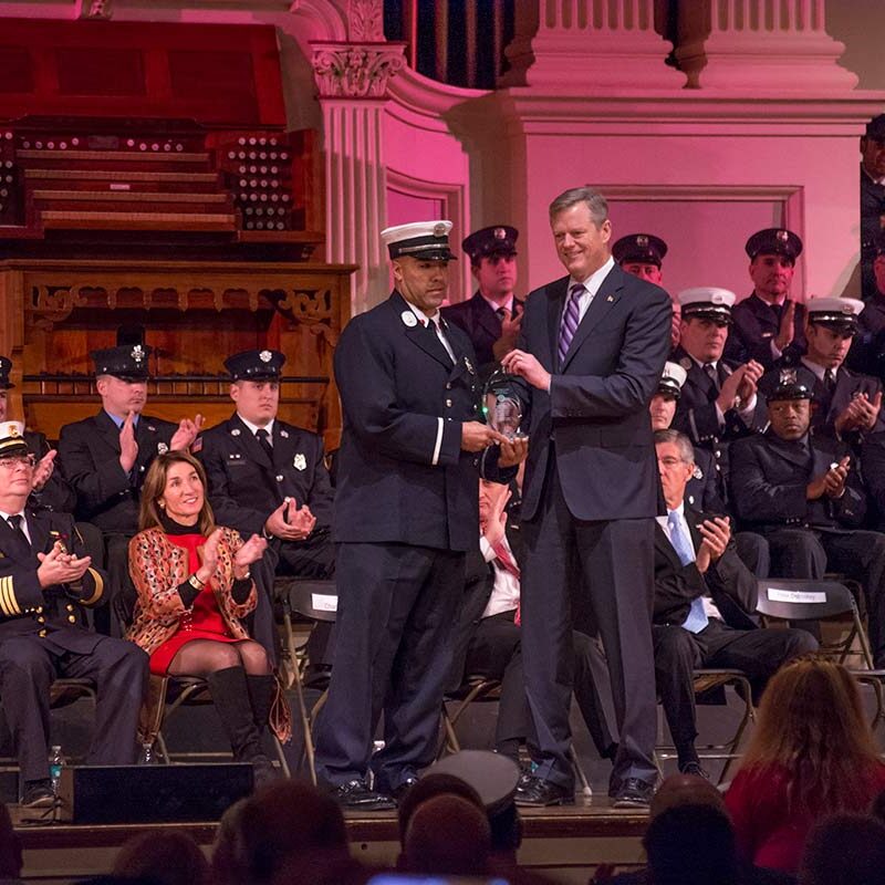 Massachusetts Governor Charlie Baker awarding firefighters.